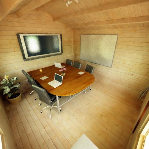 Interior of a 28mm log cabin being used as a meeting space, with large monitor, desk and chairs.