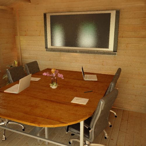 Interior of a 28mm log cabin being used as a meeting space, with large monitor, desk and chairs.