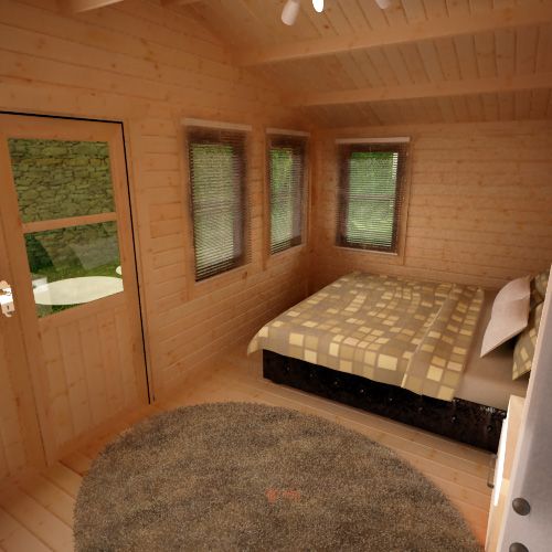 Interior of 44mm log cabin with double bed, grey circular rug, half glazed double doors and windows.