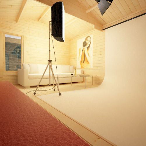 44mm log cabin being used as photography studio, with lights, white backdrop and white sofa.
