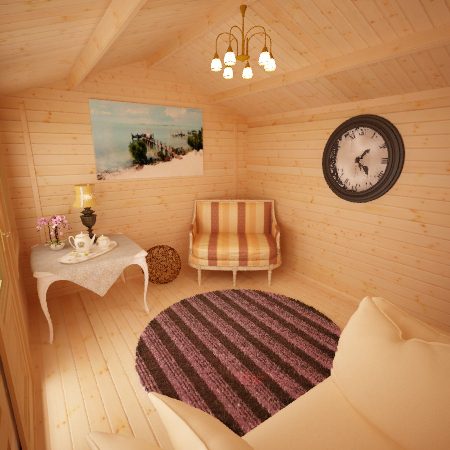 Decorated interior of 28mm log cabin, with armchair, ceiling light, wall clock and landscape painting on far wall.