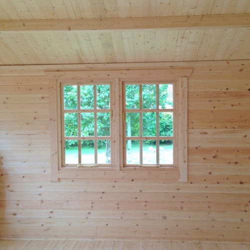 Interior view of roof, walls and window in 44mm log cabin.