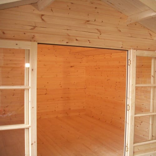 Open double doors showing interior of 44mm log cabin.