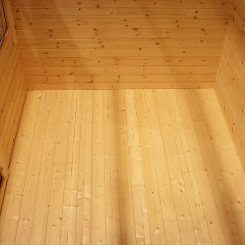 Interior wooden flooring of 28mm log cabin.