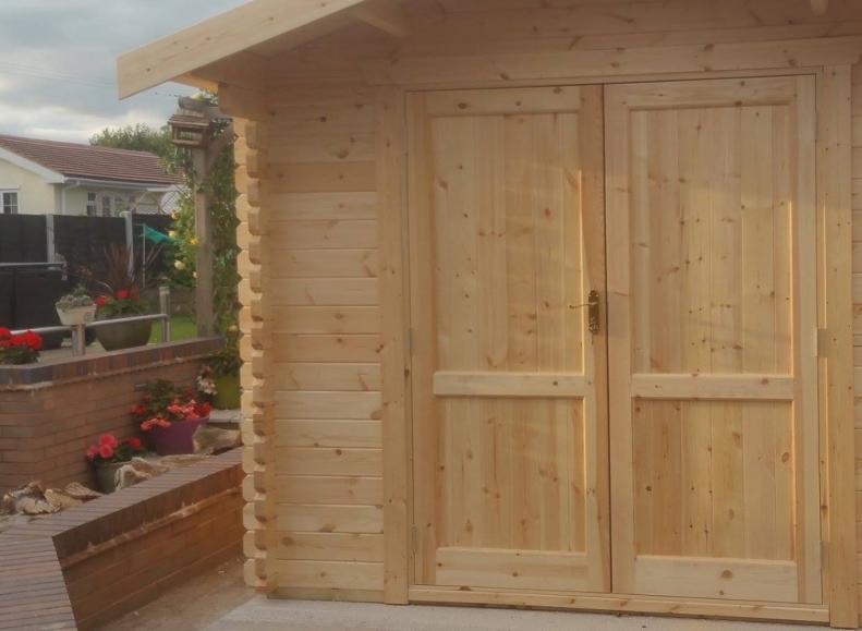 44mm log cabin with solid double doors and apex style roof.