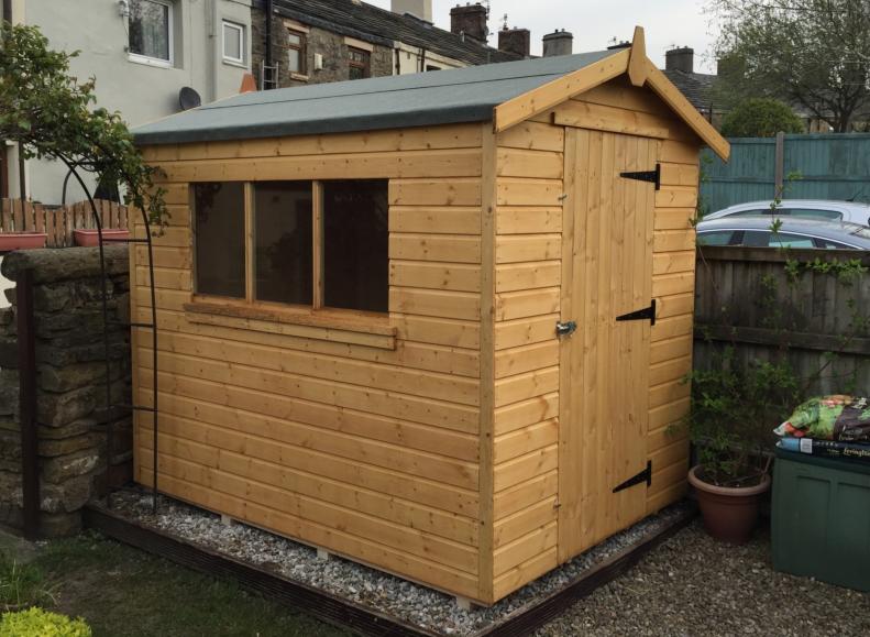 Wooden garden shed with lockable single door at the front, side window and apex roof.