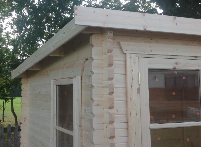 Newly constructed log cabin with front window, side window and pent style roof.