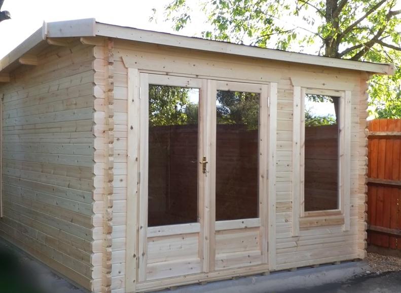 Log cabin with fully glazed double doors and window at the front, with hip style roof.