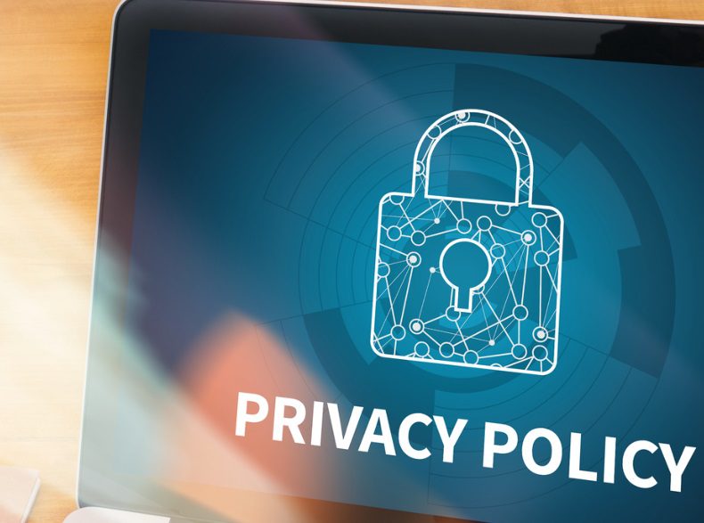 Laptop screen displaying the text privacy policy on a navy background with a graphic of a lock.
